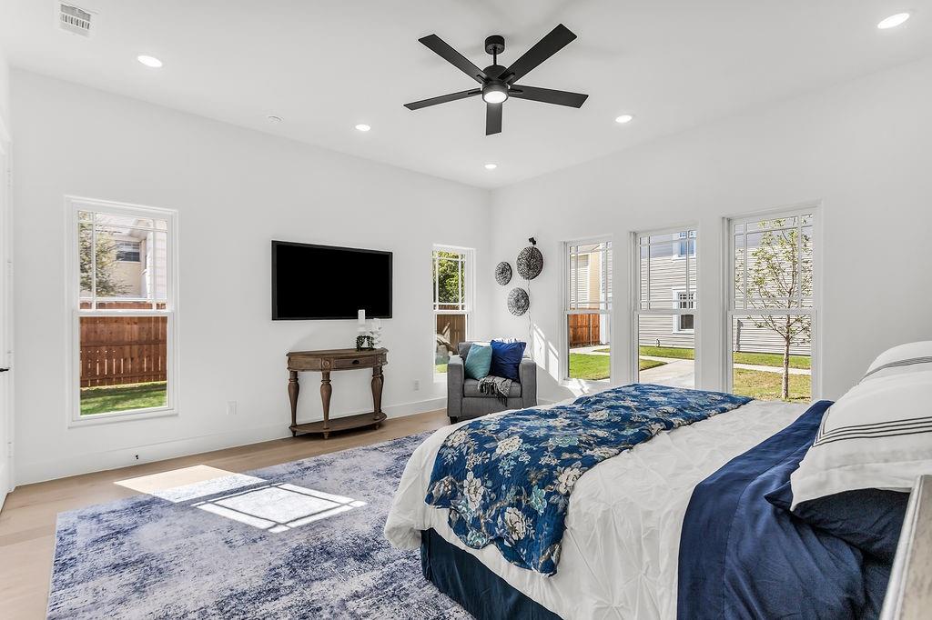 Spacious primary suite retreat with vaulted ceiling and designer finishes throughout