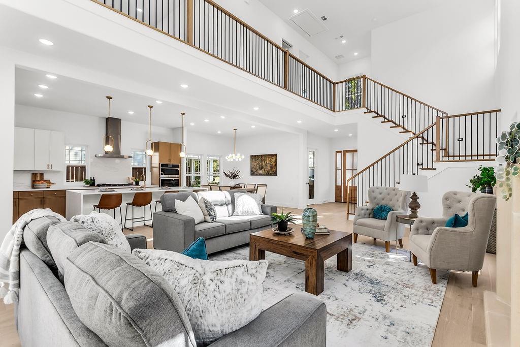 Soaring 2-story great room with gas fireplace, clerestory windows, and wide-plank white oak engineered hardwood