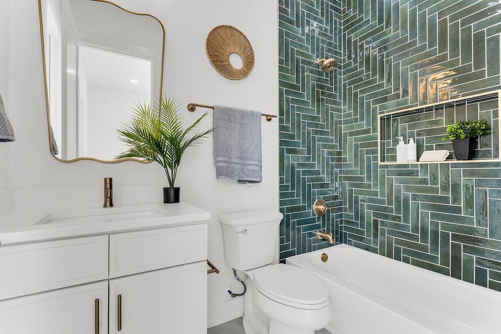 Designer full bath with quality tile work and modern fixtures — mirrors the elevated finishes found throughout the home