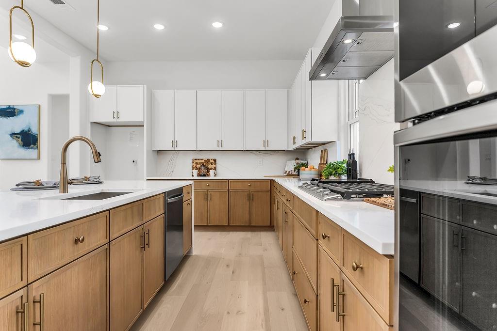 Chef’s kitchen featuring Calacatta Verona quartz waterfall island, two-tone slim shaker cabinetry, and Samsung stainless appliances