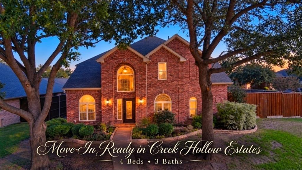 Two-story brick exterior featuring an arched entryway, decorative stone-edged landscaping, and multiple arched windows Two-story brick exterior featuring an arched entryway, decorative stone-edged landscaping, and multiple arched windows
