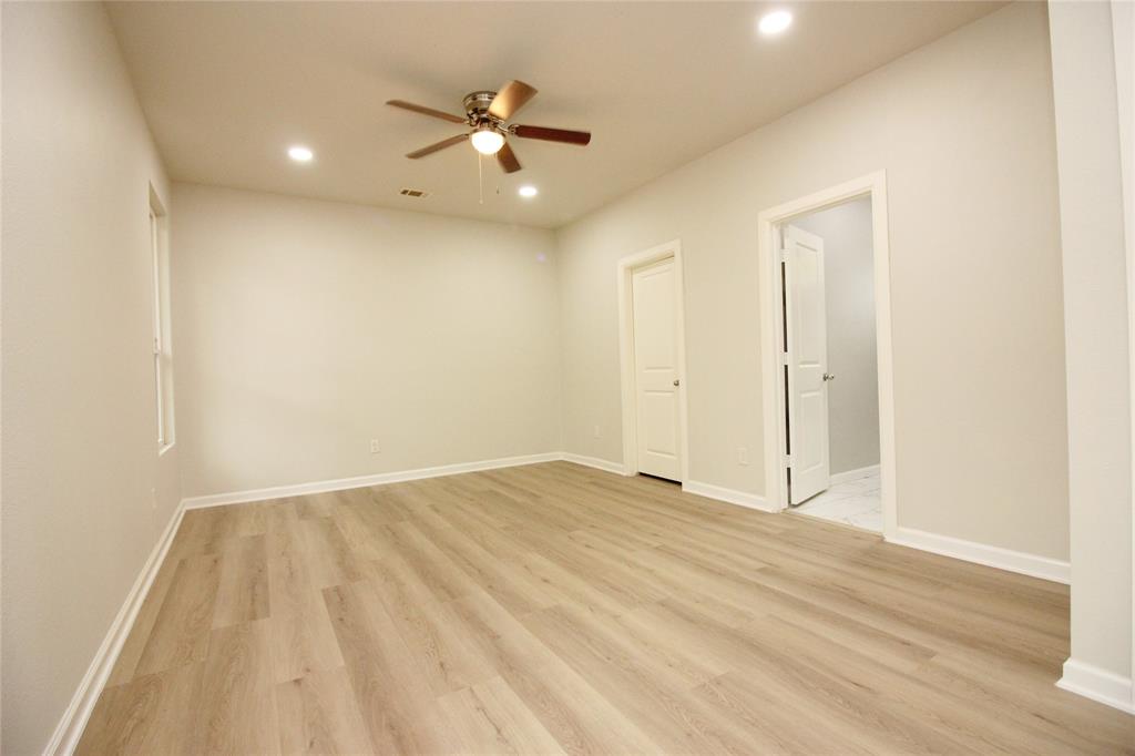 Neutral interior featuring wood-finish flooring, recessed lighting, and a central ceiling fan