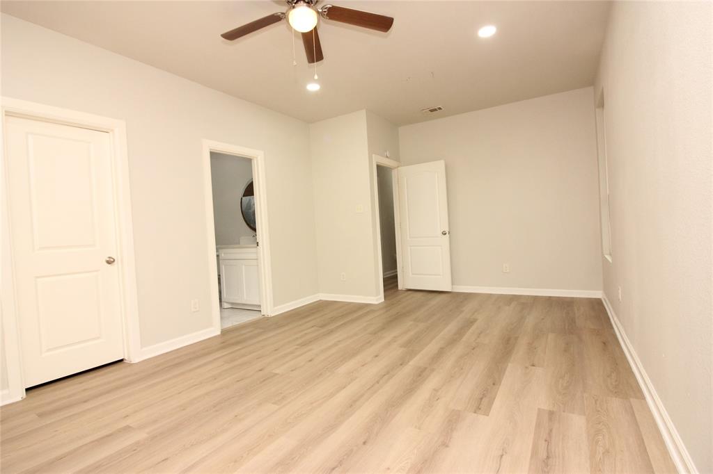 Interior space featuring wood-finish flooring, recessed lighting, a ceiling fan with integrated lighting, and multi-panel doors