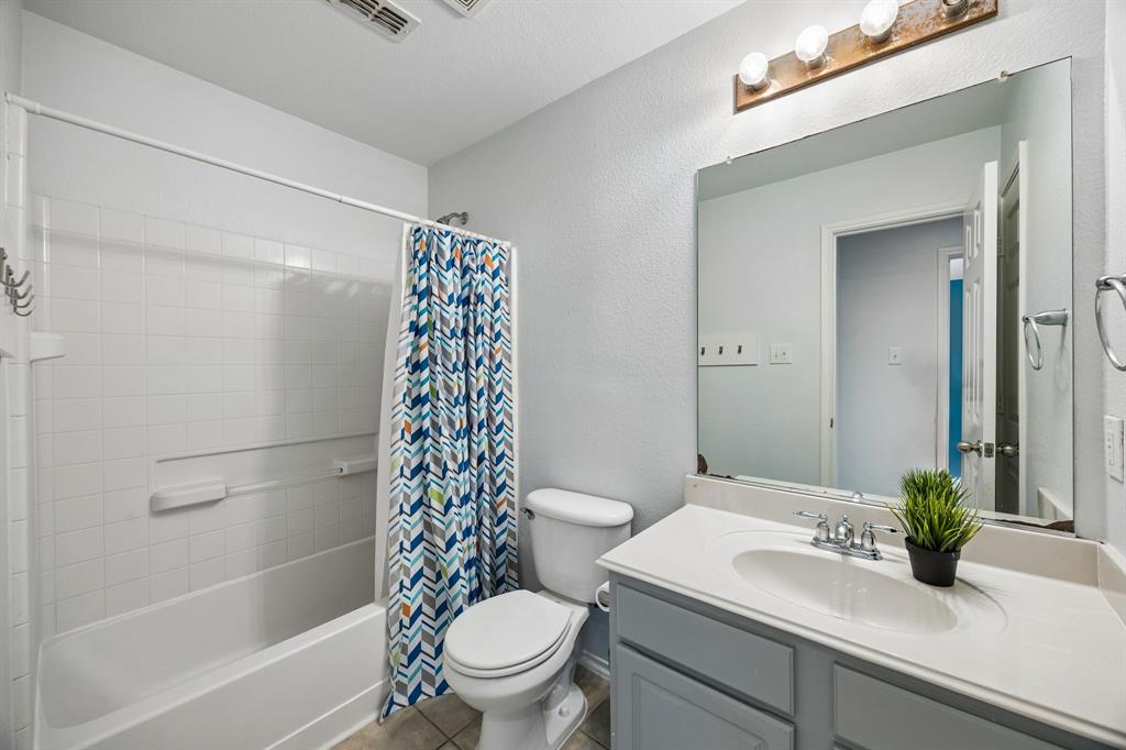 A well-appointed 2nd floor full bathroom featuring a tub and shower combination with white tile surround, a spacious vanity with a white countertop, and a large mirror that enhances the room's bright, open feel. Neutral finishes and ample lighting create a clean, functional space, while the practical layout provides everyday convenience.