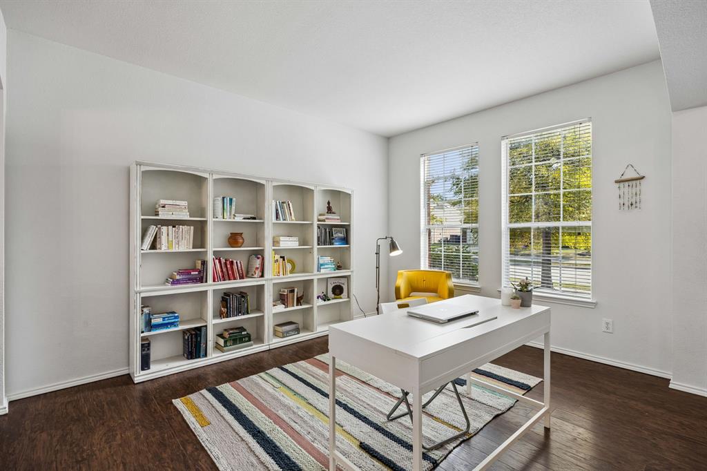 Bathed in natural light from two generous windows, this inviting study offers an inspiring setting for working from home, reading, or creative pursuits. This room offers abundant space for books and treasured accents, while warm flooring and a clean, neutral backdrop create a polished yet comfortable atmosphere.
