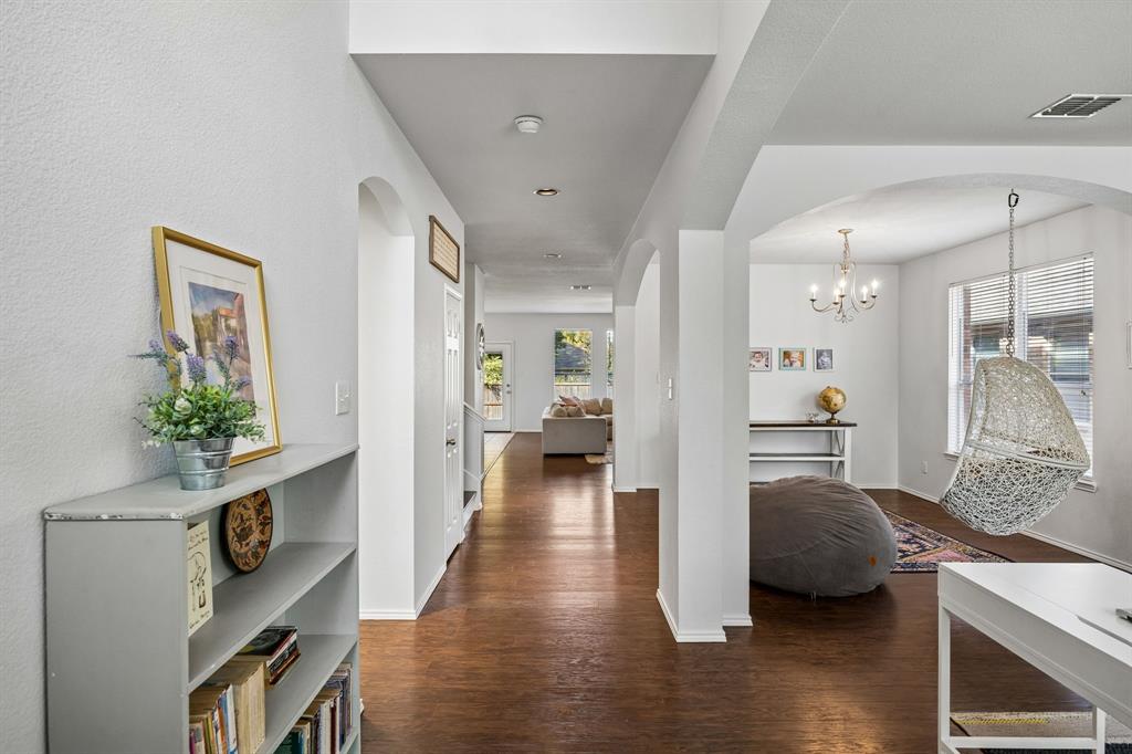 Step inside to an airy, light-filled interior where graceful archways, warm wood-look flooring, and a neutral palette establish an inviting sense of style. The open sightlines create a seamless visual connection between the entry, living spaces, and adjoining rooms, enhancing the home's spacious feel.