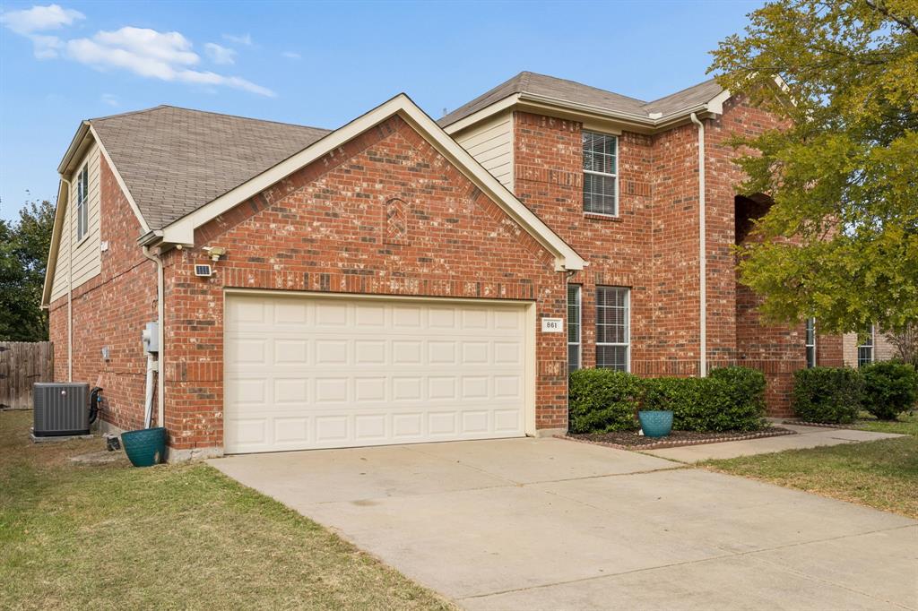 Showcasing timeless brick construction, multiple rooflines, and an attractive two-story design, this residence offers enduring curb appeal. The spacious driveway, attached two-car garage, and established landscaping create a welcoming approach to a home designed for comfortable living and entertaining.