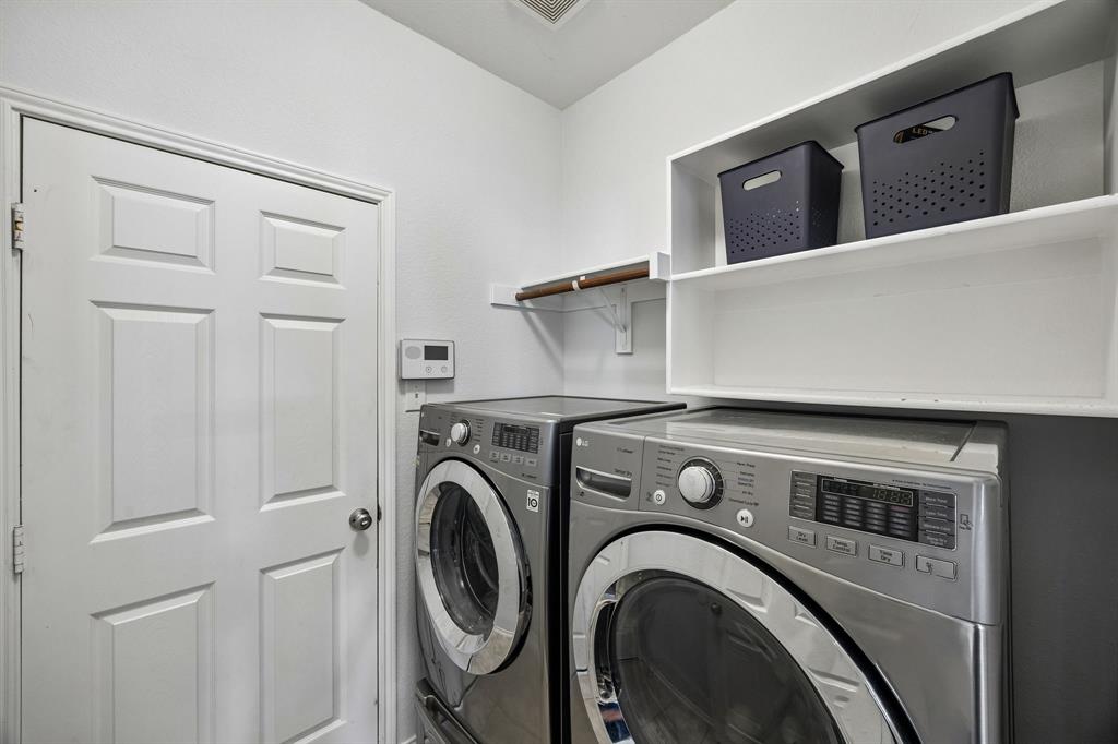 A dedicated laundry area featuring overhead storage shelving and a convenient hanging rod. The efficient layout makes the most of the available space, providing practical storage and organization options to help simplify everyday household routines. Features a full size linen closet for convenient storage.