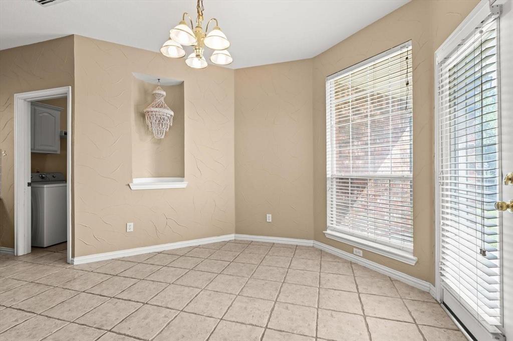 Tiled flooring, built-in wall niche, multi-light chandelier, and expansive windows