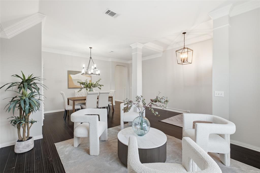 Columns and crown molding mark the formal spaces while keeping an open, airy flow. Designer light fixtures add polish throughout.