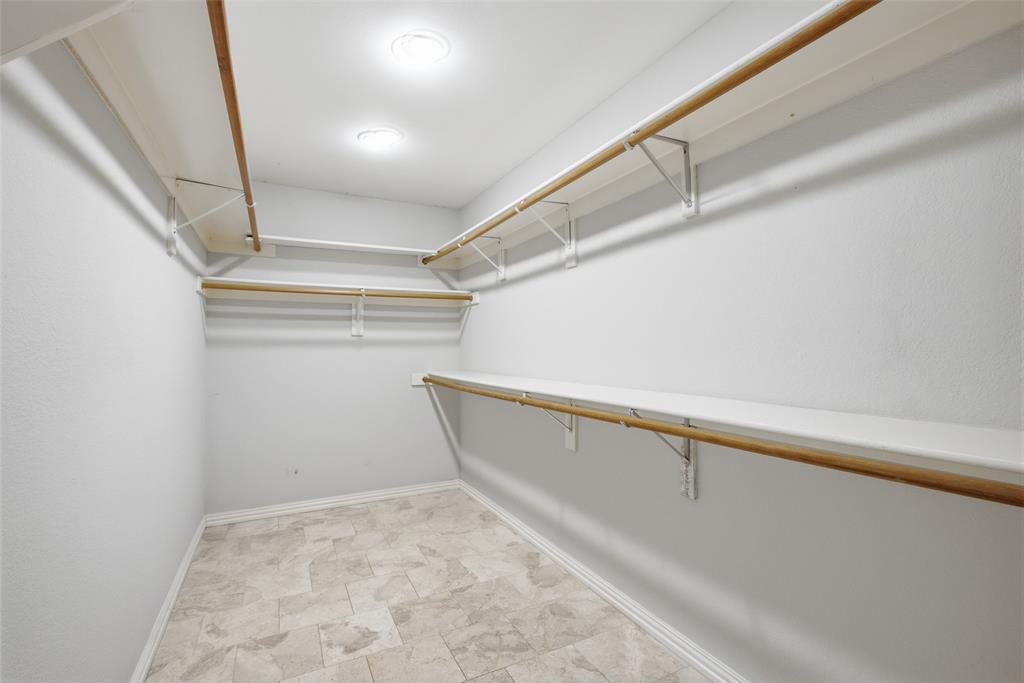 A generous walk-in closet with tile floors and double-hung rods leaves plenty of room for every season’s wardrobe.