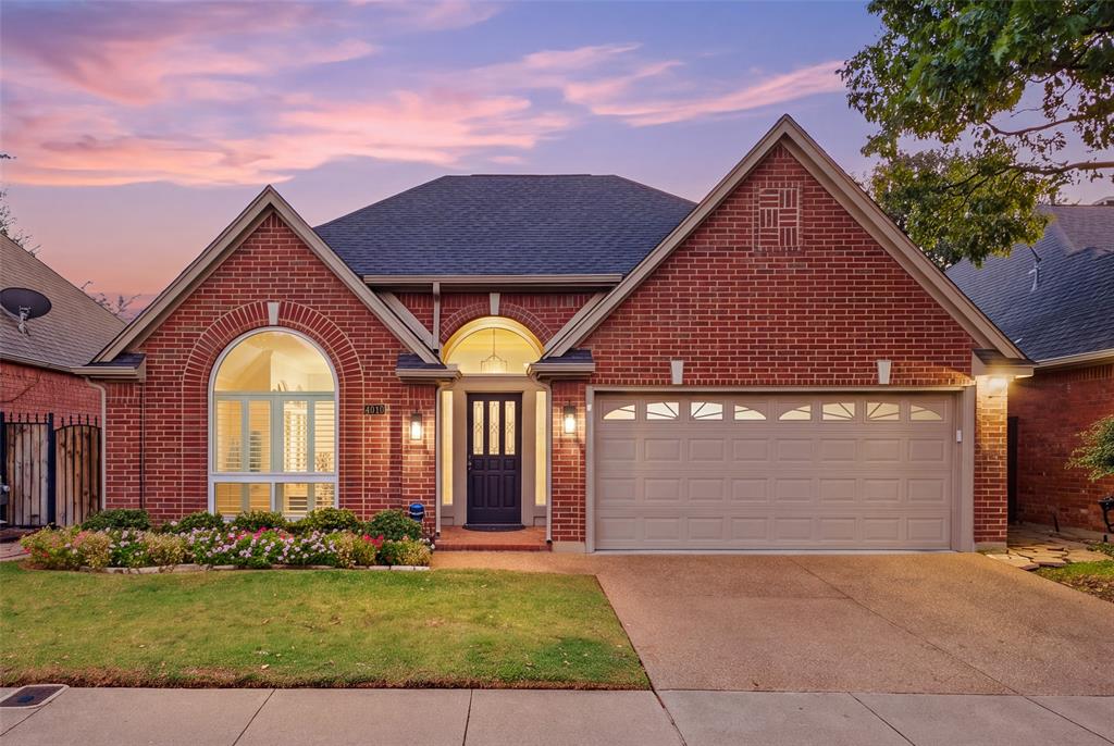 Welcome home to 4010 Azure Lane. Classic red brick, arched windows and a glowing entry set the tone for refined Addison living.