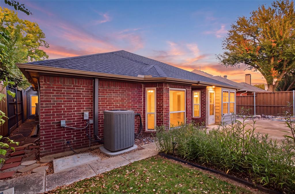 Mature trees, lush plantings and classic brick create a peaceful backyard retreat in the heart of Addison.