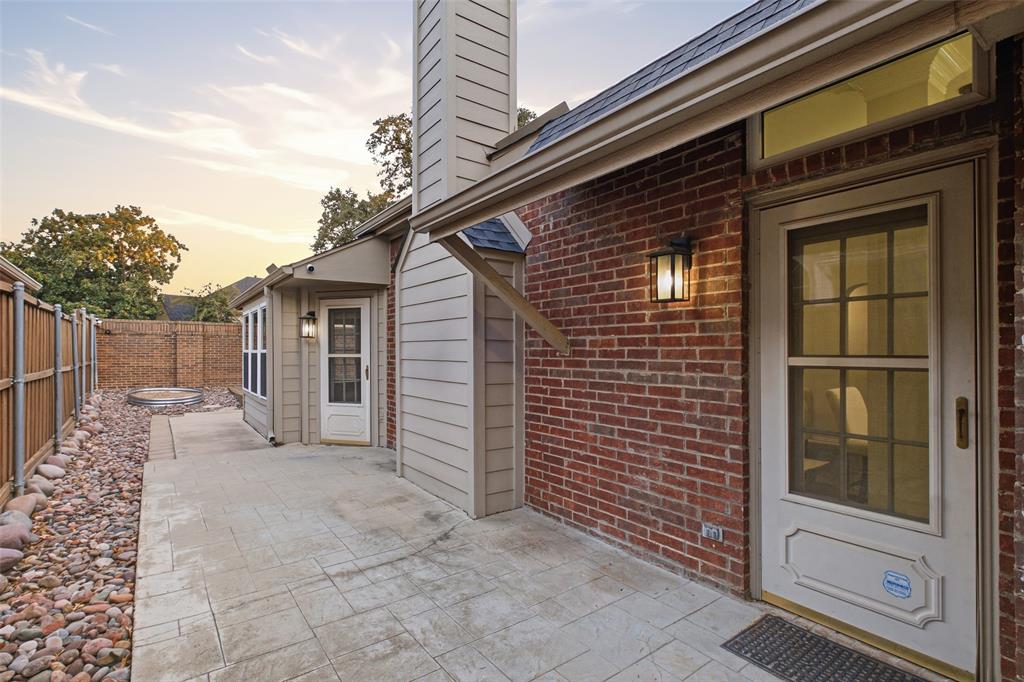Step outside for morning coffee or evening conversation on your private patio, framed by brick and mature trees.