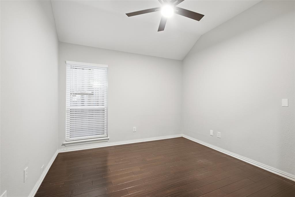 The secondary bedrooms are bright and versatile, with vaulted ceilings, ceiling fans and wood-look floors. Ideal for guests, family or a home office.