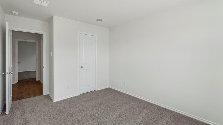 Neutral paint palette, textured carpeting, and white interior doors