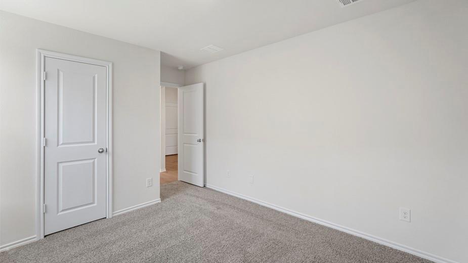 Neutral-toned walls complement plush carpeting