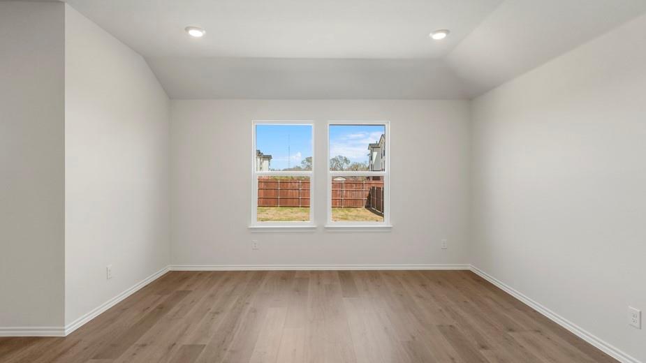Wood-finish flooring, recessed ceiling lighting, and two windows