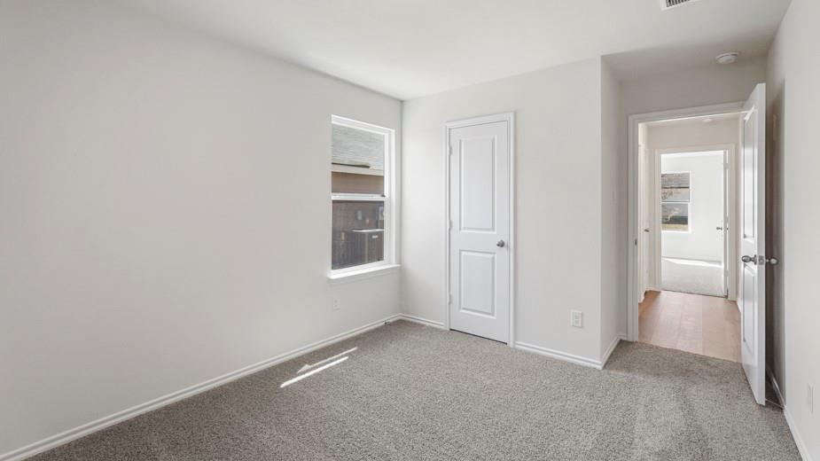Neutral wall color, carpeted flooring, white trim, and a single window