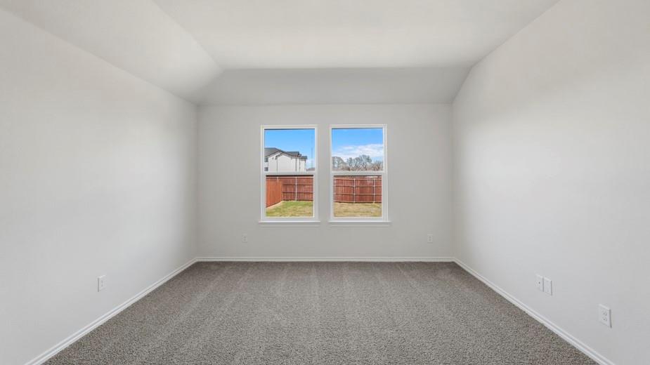 Neutral wall paint with tray ceiling, grey carpet flooring, and dual windows