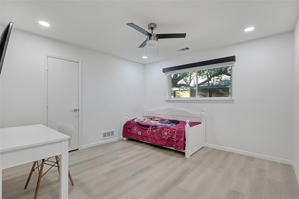 Neutral-toned wood-finish flooring, recessed lighting, and a modern ceiling fan