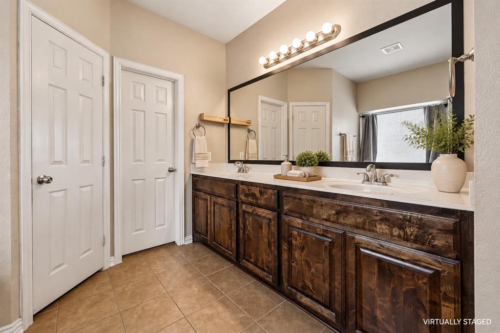 Dual sinks, spacious and separate shower, separate water closet, linen closet and dual sinks.