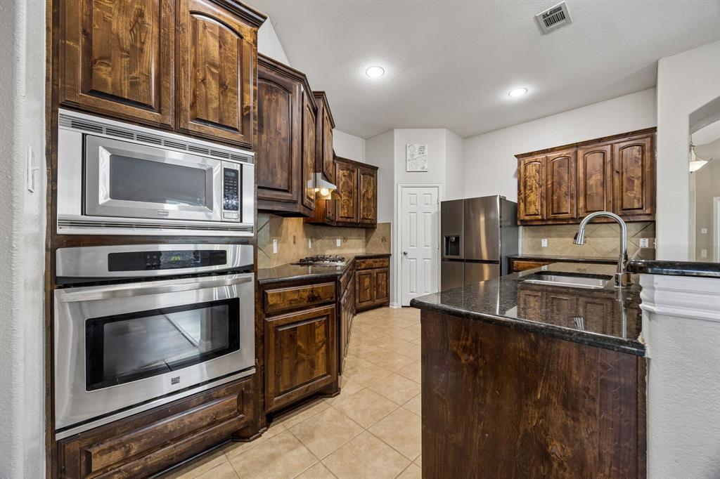 Spacious granite counter space and cabinets galore.