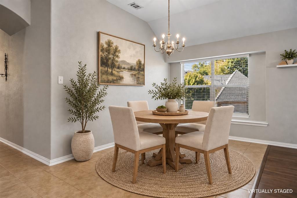 This breakfast room is open to the family room and the kitchen and is bathed in natural light.
