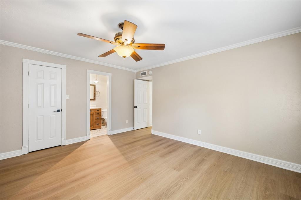 Thoughtfully finished primary suite with neutral walls, attractive wood-look flooring, and classic white crown molding, this bedroom offers a bright and adaptable retreat. Convenient access to the attached primary batheroom. The timeless color palette creates an appealing backdrop for a personalized design.