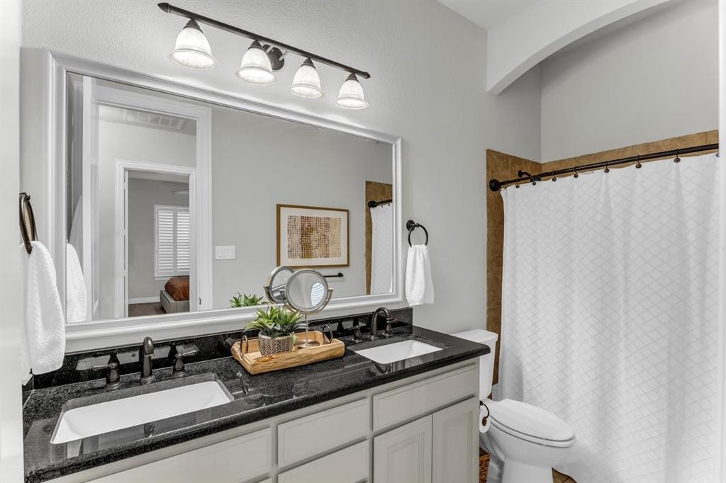 Dual vanity, bathroom located by secondary bedrooms