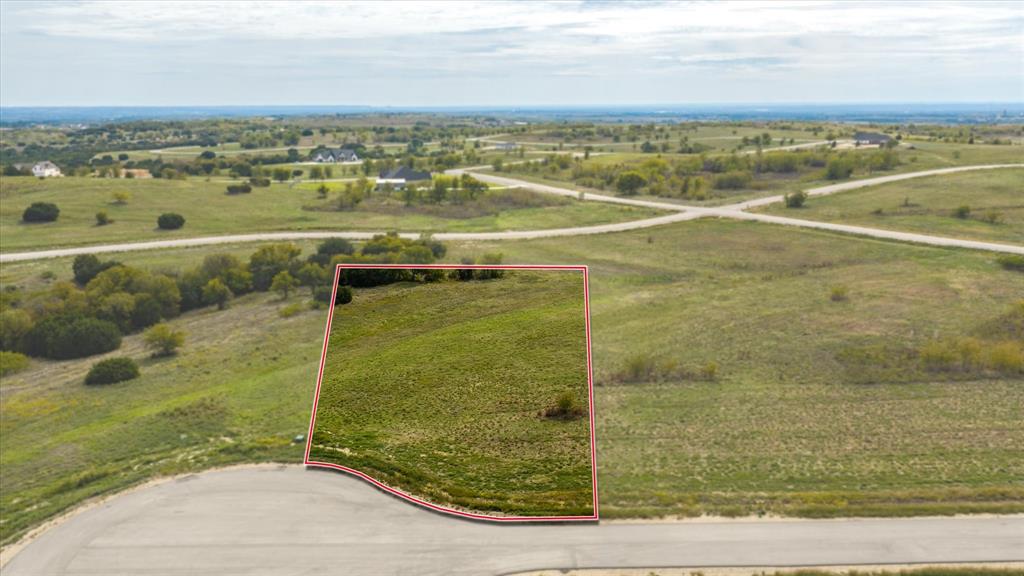 Expansive residential lot featuring open topography, frontage on a paved cul-de-sac, and native vegetation