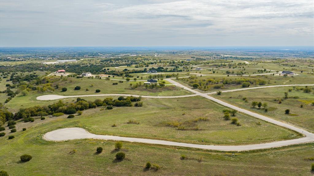 Expansive landscape featuring rolling topography, established roadways, and native vegetation