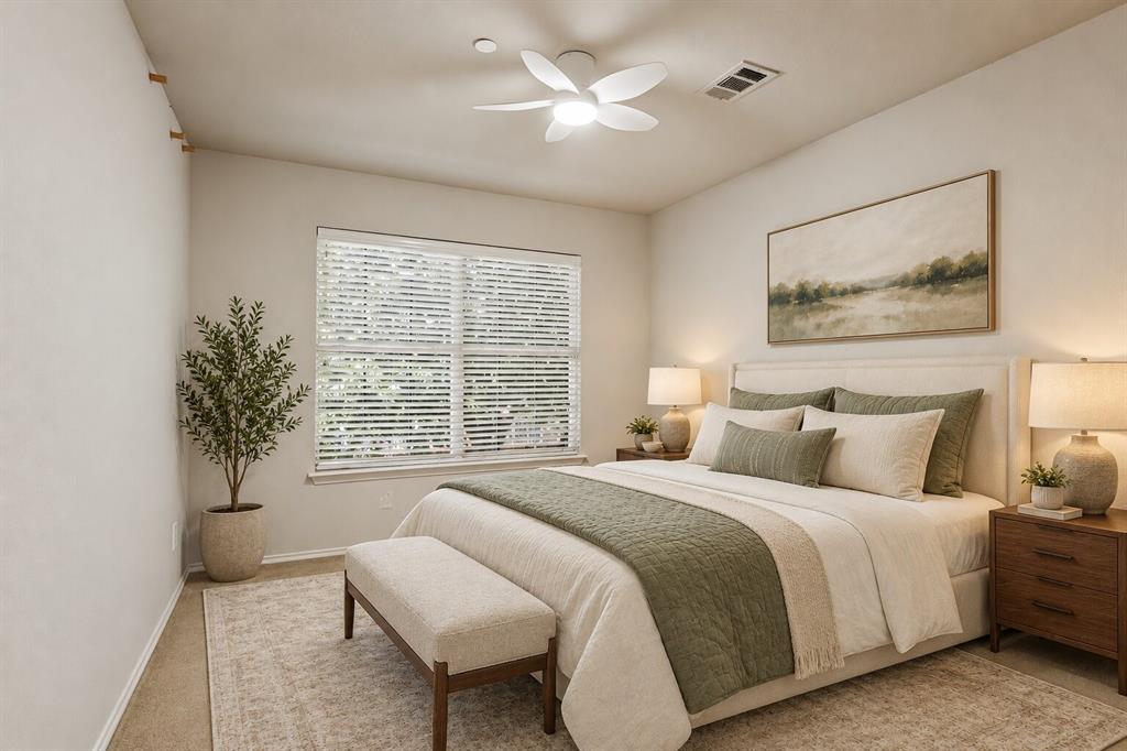 Bedroom featuring neutral wall paint, multi-pane window with horizontal blinds, and a multi-blade ceiling fan with integrated lighting