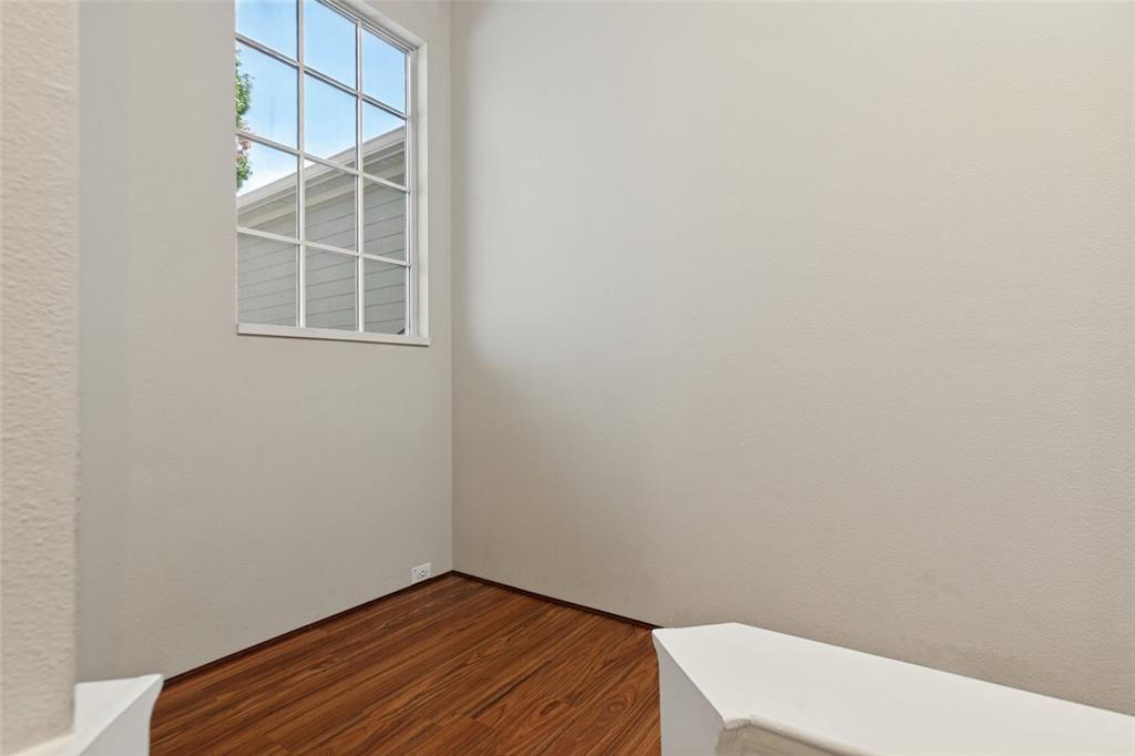 Multi-pane window featuring crisp white framing and wood-finish flooring