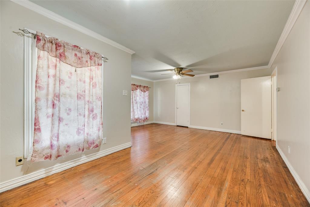 Wood-finish flooring, crown molding, and central ceiling fan with integrated lighting