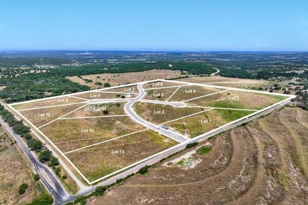 Aerial perspective of a multi-parcel development featuring paved internal roadways, cleared topography, and established perimeter boundaries