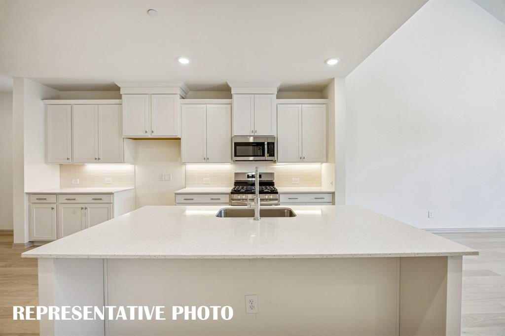 Your spacious kitchen island is the perfect place for friends and family to gather round!  REPRESENTATIVE PHOTO