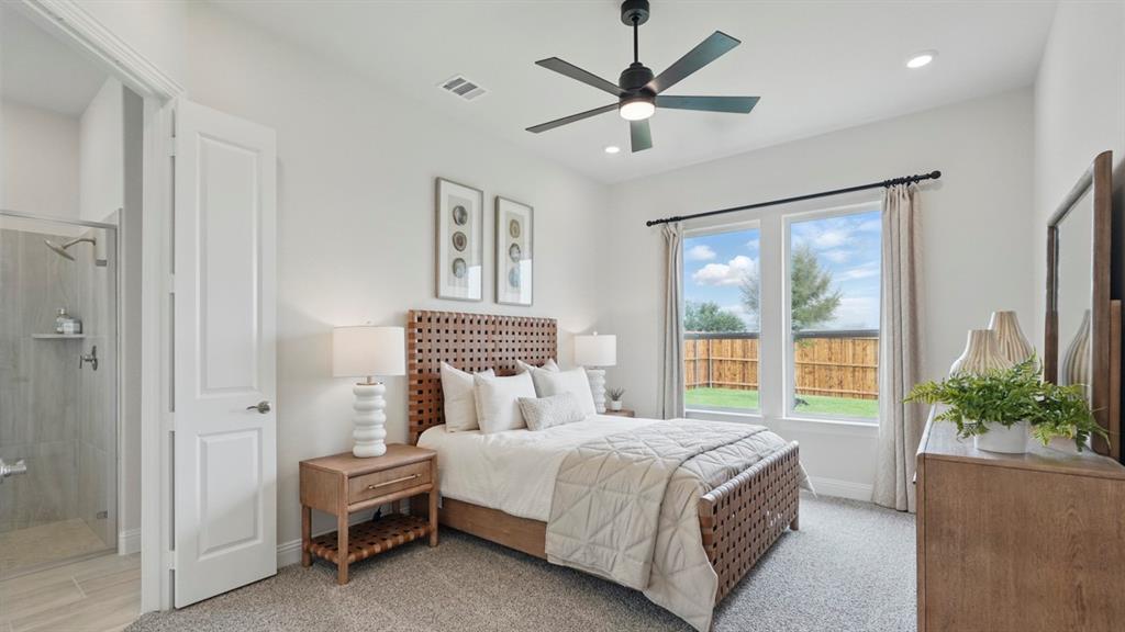 Bedroom featuring neutral carpet flooring, a central ceiling fan with integrated lighting, recessed lighting, and dual-pane windows