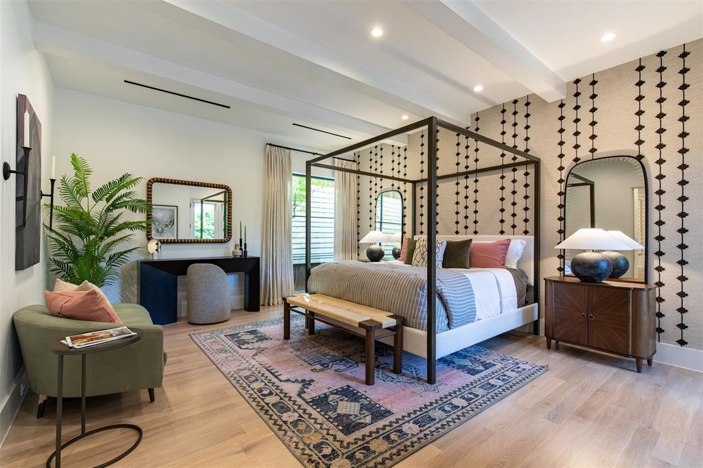 Bedroom featuring wood-finish flooring, recessed lighting, exposed ceiling beams, and a patterned accent wall