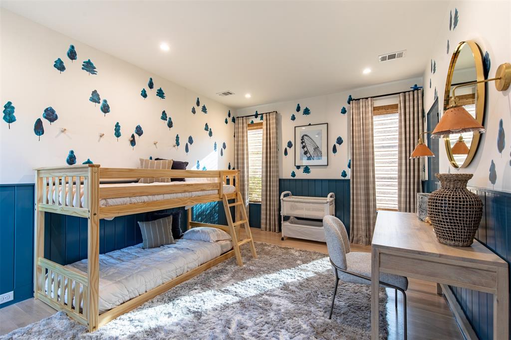 Bedroom featuring blue wainscoting, recessed lighting, and wood-finish flooring