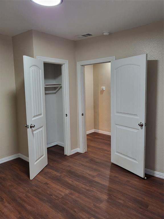 Wood-finish flooring, two-panel arched interior doors, and built-in closet shelving