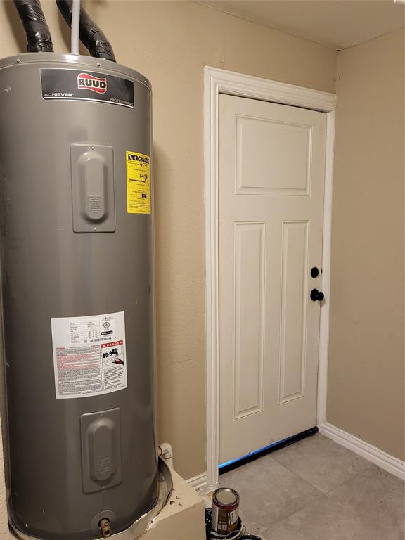Ruud water heater with an insulated tank and a six-panel door featuring dark hardware