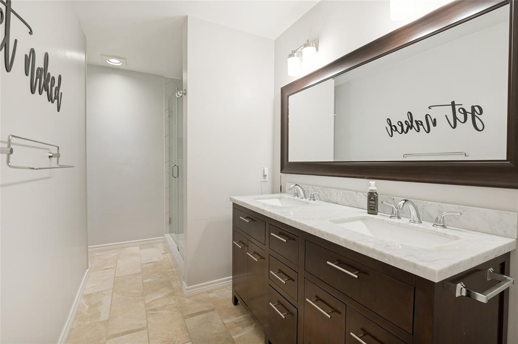 Dual sink vanity with a stone countertop and chrome fixtures