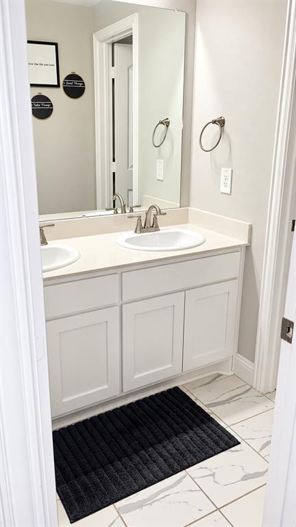 Secondary bathroom with a white vanity and clean, neutral finishes.
