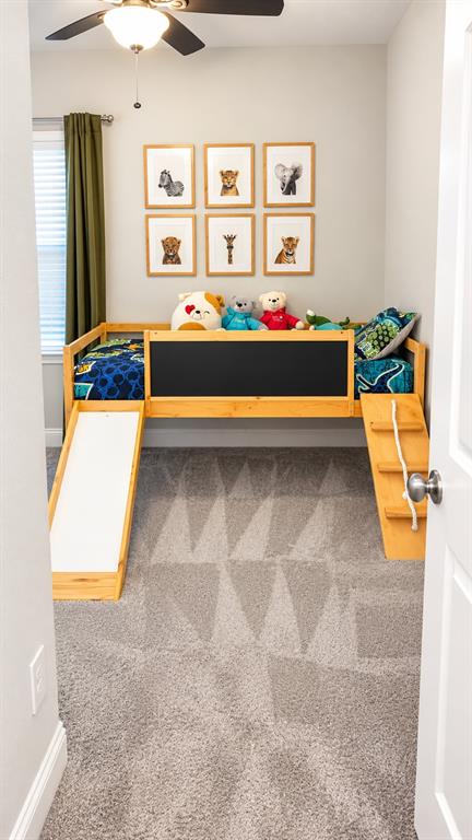 Cheerful bedroom with a ceiling fan, ready for your personal touch.