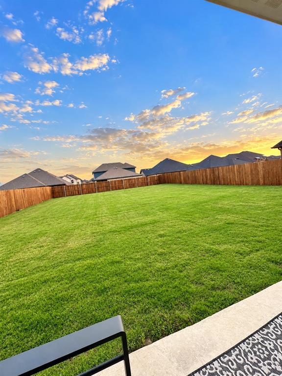 Golden-hour views over the massive backyard. Picture your evenings out here on the covered patio.