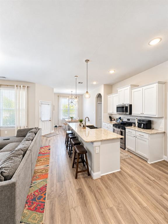 Open sightlines from the kitchen to the dining and living areas make everyday living and entertaining easy.