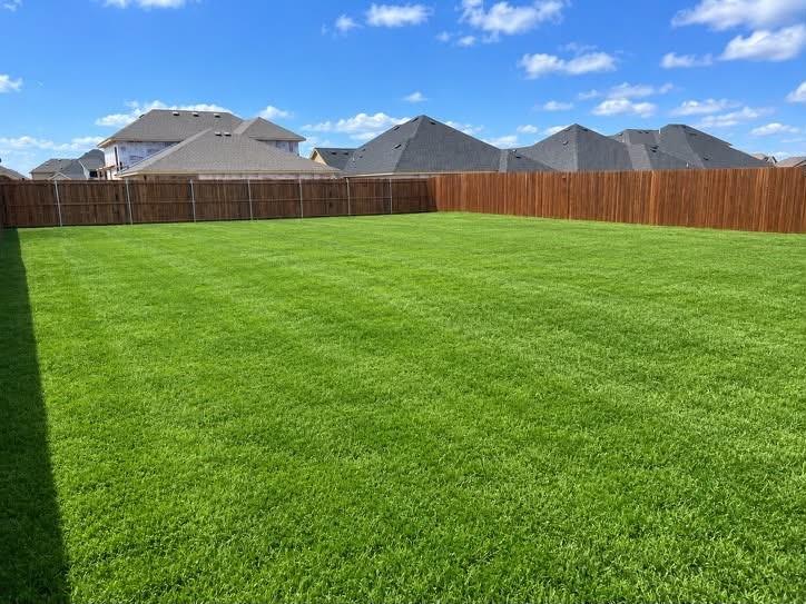 Did you see the yard? A massive, fully fenced backyard with lush lawn and plenty of room for a future pool.
