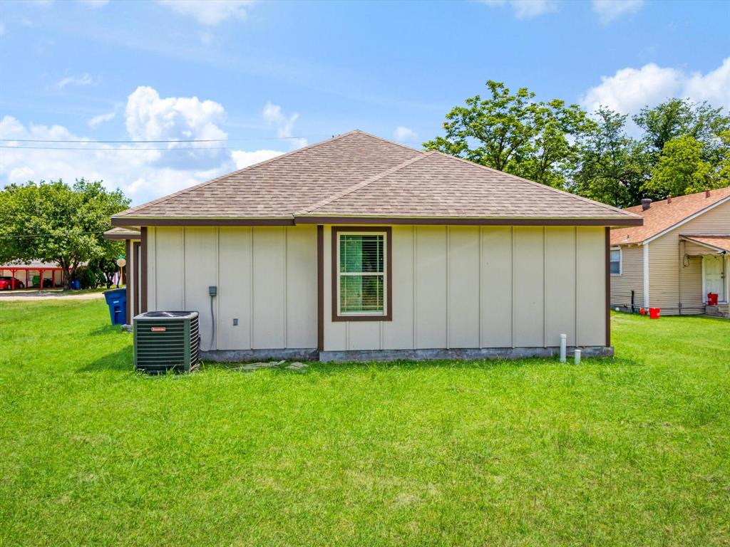 Exterior featuring vertical siding, a hip roof with asphalt shingles, and an outdoor HVAC unit