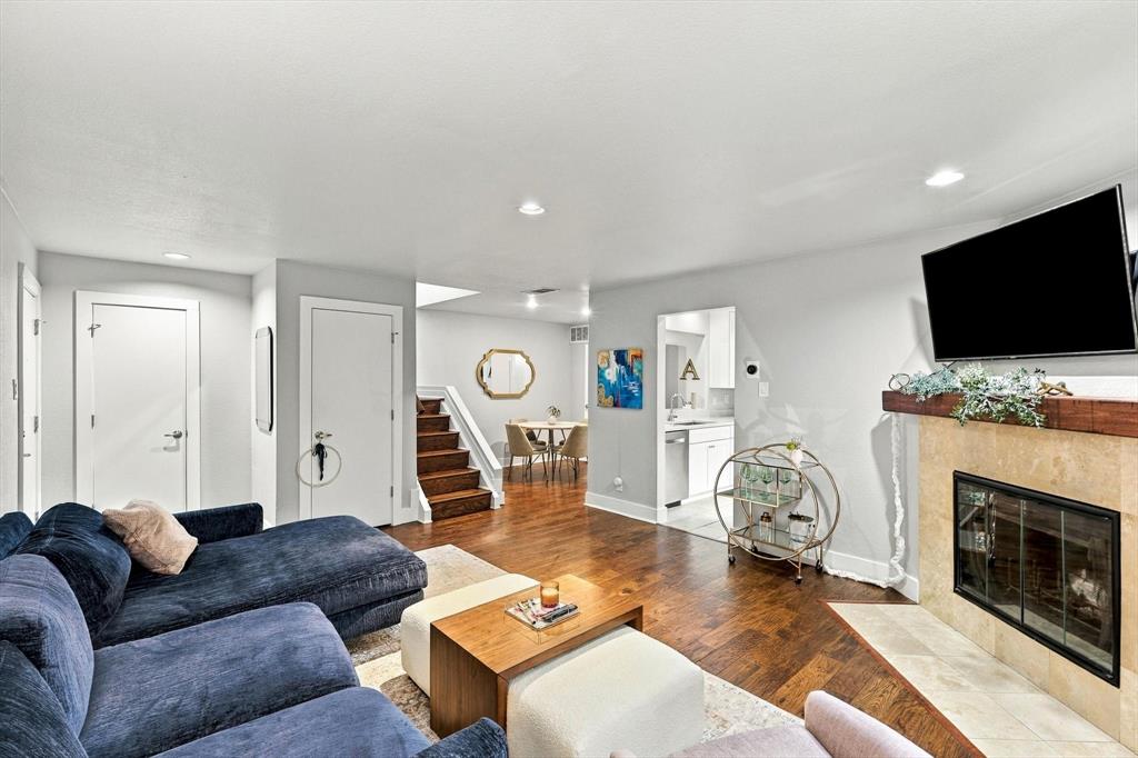 Fireplace featuring a stone-tile surround, dark wood mantel, and recessed lighting throughout